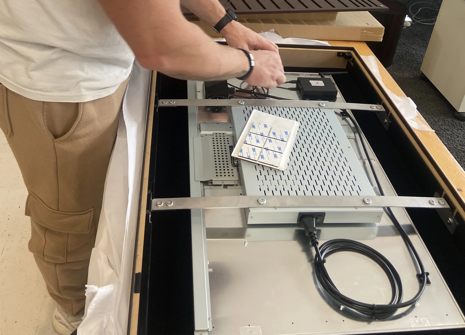 Technician servicing a display installation