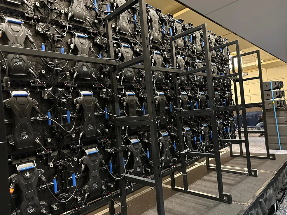 The back of an LED wall on its steel frame, the panels cabled and serviced from behind