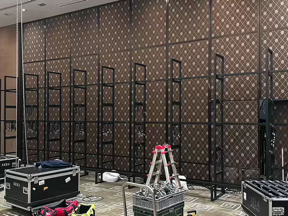 Steel ladder frames standing in a conference room before the LED panels are fitted