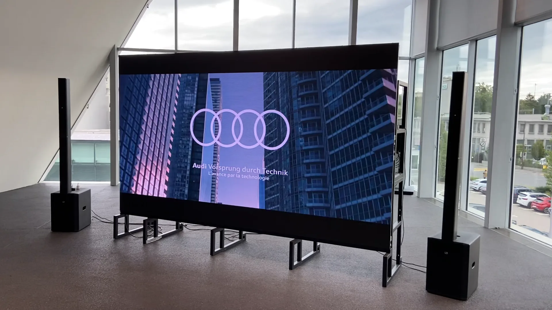LED wall on its steel frame at a car presentation, speakers on each side