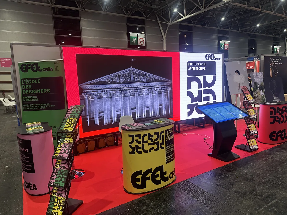 LED wall framed into a trade fair stand, a building shown on screen