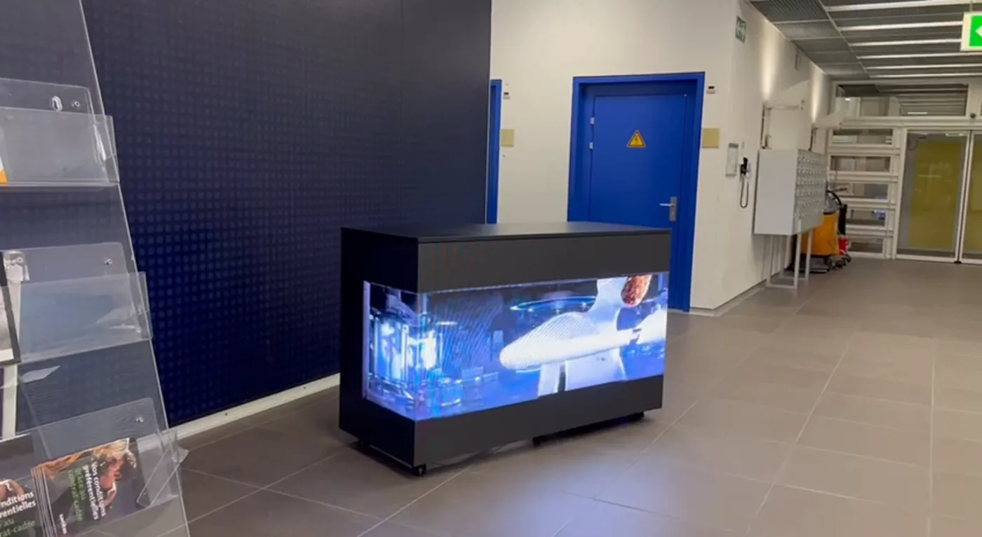 LED reception counter in a hall, a picture of water running across its front and side
