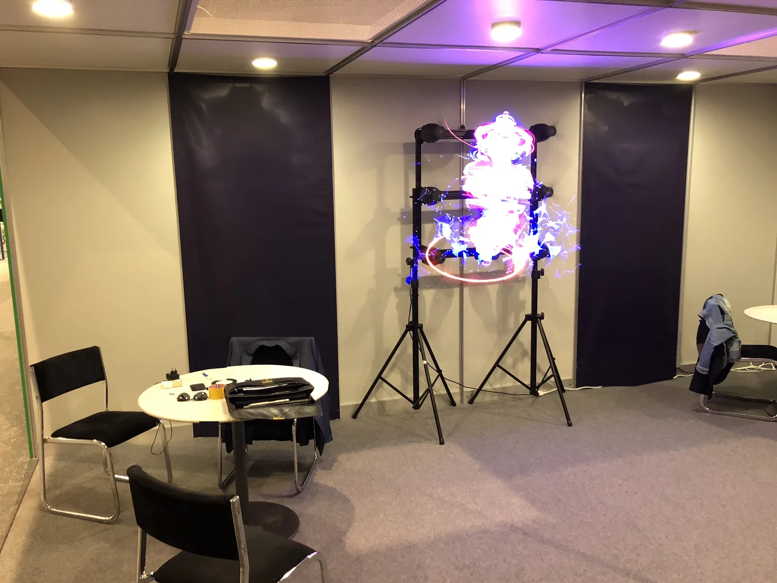 HYPERVSN hologram fans on stands at a trade-show stand, a picture floating in mid-air