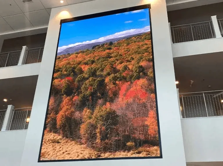 Tall portrait LED wall on a pillar in an atrium with balconies