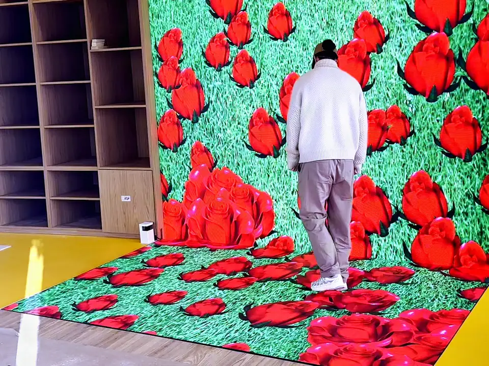 Interactive LED floor showing a field of red roses under the feet of a visitor