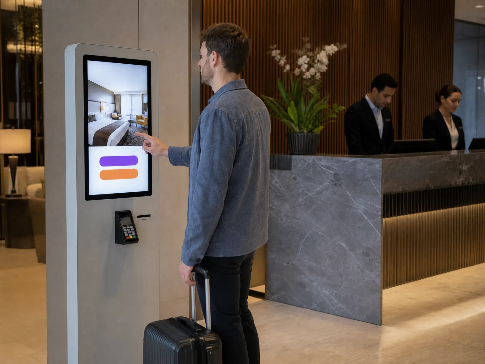 Traveller with a suitcase at a check-in kiosk beside a hotel reception desk