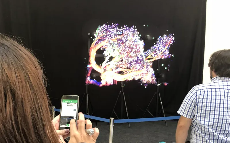 A visitor films one of our HYPERVSN holographic displays with her phone